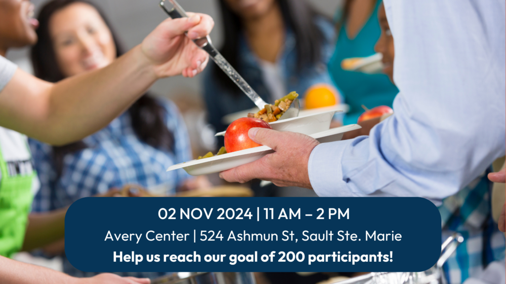 A person receives a plate of food. Overlaying the image is a rounded blue rectangle with white text displaying event details:

02 NOV 2024 | 11 AM – 2 PM
Avery Center | 524 Ashmun St, Sault Ste. Marie

Help us reach our goal of 200 participants!